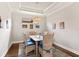 Formal dining room features tray ceiling, chandelier, and charming decor with wicker chairs at 13338 Torresina Ter, Lakewood Ranch, FL 34211