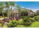 Beautiful exterior with lush tropical landscaping surrounding the home and a paver driveway at 13338 Torresina Ter, Lakewood Ranch, FL 34211