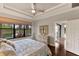Relaxing main bedroom with tray ceiling, water view, and an ensuite bathroom at 13338 Torresina Ter, Lakewood Ranch, FL 34211