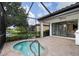 Covered and screened patio features a spa and backyard views at 13338 Torresina Ter, Lakewood Ranch, FL 34211