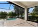 Screened-in patio with a spa overlooking a tranquil lake at 13338 Torresina Ter, Lakewood Ranch, FL 34211