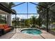 A screened-in pool area with a water view and a brick-paved deck, perfect for outdoor relaxation and entertaining at 13338 Torresina Ter, Lakewood Ranch, FL 34211