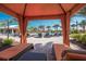 Relaxing poolside cabana with comfortable loungers overlooking the swimming pool at 13338 Torresina Ter, Lakewood Ranch, FL 34211
