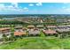 Aerial view of a community featuring well-maintained homes, serene lakes, and lush green spaces at 13609 Messina Loop # 104, Bradenton, FL 34211