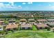 Aerial view of a residential neighborhood featuring multi-Gathering homes, lakes, and lush landscaping at 13609 Messina Loop # 104, Bradenton, FL 34211