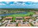 Aerial view of homes in a golf course community featuring a lake and lush landscaping at 13609 Messina Loop # 104, Bradenton, FL 34211