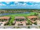 Aerial view of a neighborhood with lake and golf course views, lush trees and well-maintained homes at 13609 Messina Loop # 104, Bradenton, FL 34211