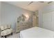 Comfortable bedroom with dresser, chair, and an ensuite bathroom at 13609 Messina Loop # 104, Bradenton, FL 34211