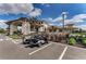 Clubhouse exterior view showcasing convenient golf cart parking and lush landscaping at 13609 Messina Loop # 104, Bradenton, FL 34211