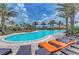 Beautiful community pool with lounge chairs and umbrellas for residents to enjoy at 13609 Messina Loop # 104, Bradenton, FL 34211
