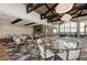 Open dining room area with lots of seating, wood beam ceilings, and lots of windows at 13609 Messina Loop # 104, Bradenton, FL 34211