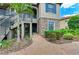 Exterior view of a home with stone accents, lush landscaping, and a brick-paved walkway at 13609 Messina Loop # 104, Bradenton, FL 34211