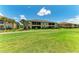 Beautiful two-story condo building overlooking a pristine green golf course, showcasing lush landscaping at 13609 Messina Loop # 104, Bradenton, FL 34211