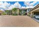 Exterior of a multi-Gathering home with attached garages and brick-paved driveway, lush landscaping at 13609 Messina Loop # 104, Bradenton, FL 34211