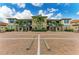 Multi-Gathering condo with stone accents, complemented by mature landscaping, and marked parking spaces at 13609 Messina Loop # 104, Bradenton, FL 34211