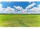 Expansive green golf course under a beautiful blue sky with fluffy white clouds in a residential community at 13609 Messina Loop # 104, Bradenton, FL 34211