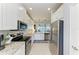 Open kitchen featuring stainless steel appliances, granite countertops, and seamless transition to the outdoor living space at 13609 Messina Loop # 104, Bradenton, FL 34211