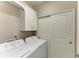 Laundry room featuring white cabinets above a side-by-side washer and dryer at 13609 Messina Loop # 104, Bradenton, FL 34211