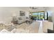 Bright living room with modern decor, stylish furniture, and a view of the screened-in patio at 13609 Messina Loop # 104, Bradenton, FL 34211