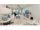 Bright living room with modern decor, stylish furniture, and a view of the screened-in patio at 13609 Messina Loop # 104, Bradenton, FL 34211