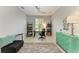 Modern home office with a ceiling fan, a large window and shelves, plus a stylish desk, chair, and rug at 13609 Messina Loop # 104, Bradenton, FL 34211