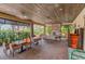 Inviting outdoor lounge area featuring comfortable seating, a cozy fireplace, and a stylish wood-paneled ceiling at 13609 Messina Loop # 104, Bradenton, FL 34211