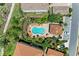 Aerial view of a community pool with lounge chairs surrounded by landscaped grounds at 13609 Messina Loop # 104, Bradenton, FL 34211