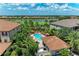 Community pool with lounge chairs surrounded by lush landscaping and well-maintained lawns at 13609 Messina Loop # 104, Bradenton, FL 34211