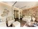 A lounge in a modern spa with a stone wall, soft seating, ambient lighting, and decorative accents at 13609 Messina Loop # 104, Bradenton, FL 34211