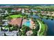 Aerial view of a resort-style pool and spa featuring lounge seating, cabanas and fire pit in a private community at 13609 Messina Loop # 104, Bradenton, FL 34211