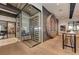 Modern wine room with glass enclosure and circular wood shelving unit on hardwood floors at 13609 Messina Loop # 104, Bradenton, FL 34211