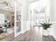 Elegant foyer with chandelier, neutral walls, hardwood floors, and glass French doors leading to the living room at 13871 Heartwood Way, Parrish, FL 34219