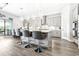 Open kitchen with gray cabinets, stainless steel appliances, white countertops, and a center island with seating at 13871 Heartwood Way, Parrish, FL 34219