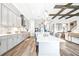Open-concept kitchen and living room with modern gray cabinets, a center island, and hardwood floors throughout at 13871 Heartwood Way, Parrish, FL 34219