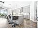Open kitchen with gray cabinets, stainless steel appliances, white countertops, and a center island with seating at 13871 Heartwood Way, Parrish, FL 34219