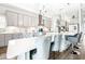 Modern kitchen featuring a center island with seating, stainless steel appliances, and a combined dining area at 13871 Heartwood Way, Parrish, FL 34219