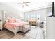 Spacious bedroom with tray ceilings, natural light, and seating area at 13871 Heartwood Way, Parrish, FL 34219