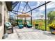 Outdoor seating area with comfortable lounge chairs, tropical decor, and views of the lush landscape at 13871 Heartwood Way, Parrish, FL 34219