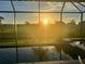 Sunset view of the screened-in pool and outdoor living space at 13871 Heartwood Way, Parrish, FL 34219