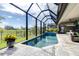 A screened-in swimming pool surrounded by lush landscaping and offering privacy and relaxation at 13871 Heartwood Way, Parrish, FL 34219