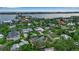 An aerial view of a neighborhood with waterfront views and beautiful houses surrounded by lush greenery at 1808 Coquina Dr, Sarasota, FL 34231