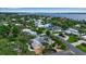 An aerial view showcases a waterfront community with beautiful homes, mature trees, and picturesque waterways at 1808 Coquina Dr, Sarasota, FL 34231