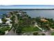 Aerial view of a waterfront community featuring beautiful houses, lush greenery, and stunning views of the bay at 1808 Coquina Dr, Sarasota, FL 34231