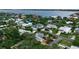 An aerial view of an upscale neighborhood with beautiful houses, lush greenery, and stunning waterfront views at 1808 Coquina Dr, Sarasota, FL 34231