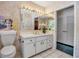 Charming bathroom featuring neutral wallpaper, tiled floor, and bright vanity lighting at 1808 Coquina Dr, Sarasota, FL 34231