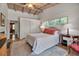 Comfortable bedroom with natural light, vaulted ceilings, wood floors, and closet space at 1808 Coquina Dr, Sarasota, FL 34231