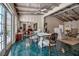 Bright dining room with beamed ceilings, unique tile flooring, and glass table set at 1808 Coquina Dr, Sarasota, FL 34231