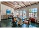 Bright dining area with large windows, a decorative table, and unique flooring at 1808 Coquina Dr, Sarasota, FL 34231