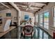 Bright dining room with beamed ceilings and glass doors to outside at 1808 Coquina Dr, Sarasota, FL 34231