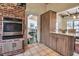 Kitchen featuring a brick column, wood cabinets, stainless appliances and view to living area at 1808 Coquina Dr, Sarasota, FL 34231